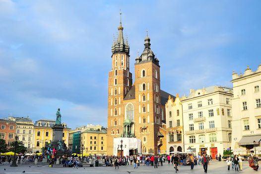 KRAKOW, POLAND - AUGUST27, 2013: Tourists at the Market Square in Krakow . Main Market Square, one of the largest medieval squares in Europe, was built in 1257.