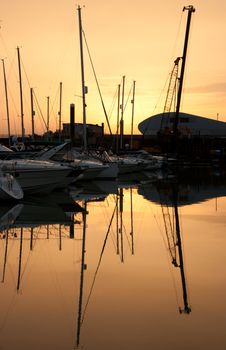 View of marina boats silhouette reflection at sunset 