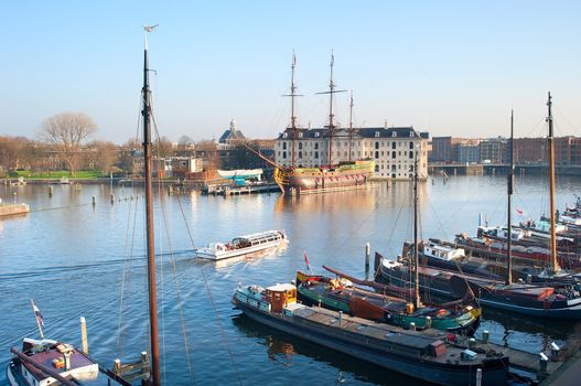 Water excursion by the Amstel river in Amsterdam, Netherlands. National Maritime Museum in the background