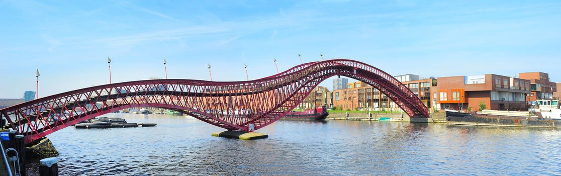 The red Python bridge in Amsterdam, Netherlands. It's shape looks like a red snake.
