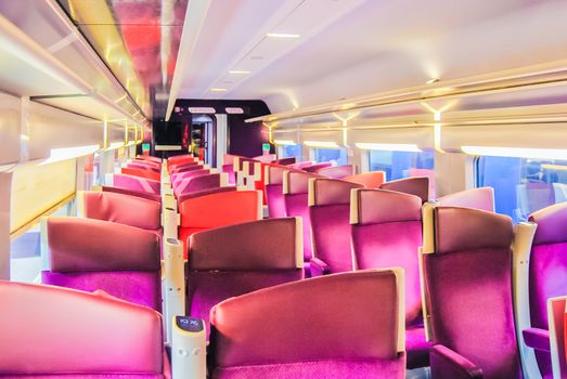 empty suburb train interior with rows of seats