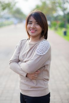 Portrait Asian woman standing in a garden and smiling.