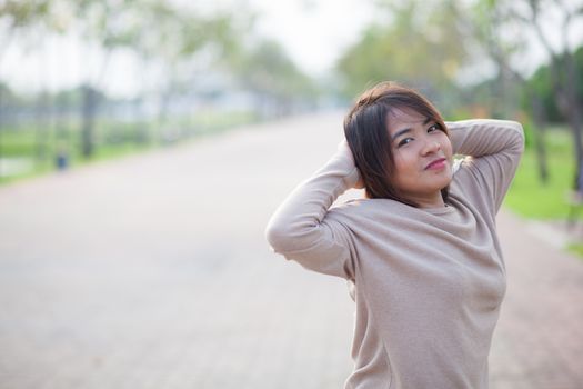 Portrait Asian woman in a park. Relax and have fun in the park.