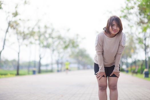 Portrait Asian woman in a park. Relax and have fun in the park.