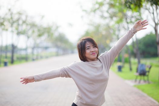 Portrait Asian woman in a park. Relax and have fun in the park.