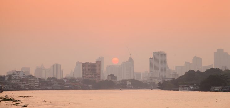 Bangkok city in morning.Tallest building in town And the river through the city. Sun rising in the morning.