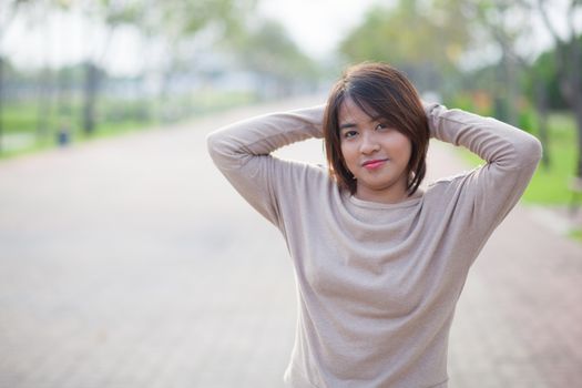 Portrait Asian woman in a park. Relax and have fun in the park.