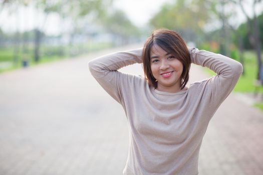 Portrait Asian woman in a park. Relax and have fun in the park.