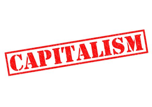CAPITALISM red Rubber Stamp over a white background.