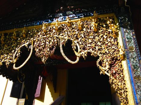 the complicated detail of wooden gate entrance at Wat Sri Chum,Lampang,Thailand