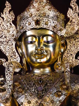 the burmese style buddha image that decorated by golden plates and precious stones,Mae Hong son,Thailand