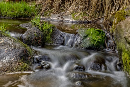 Falls on the small mountain river in a wood in spring