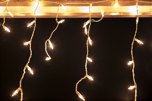 white christmas lights on roof against dark background
