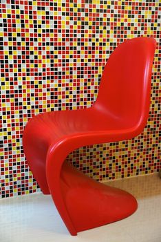 fiber red chairs on colourful background