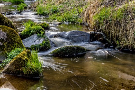 Falls on the small mountain river in a wood in spring