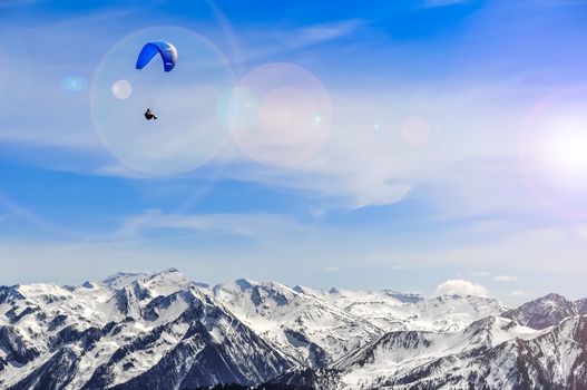 Winter mountains landscape and man paragliding, Kaprun, Austria