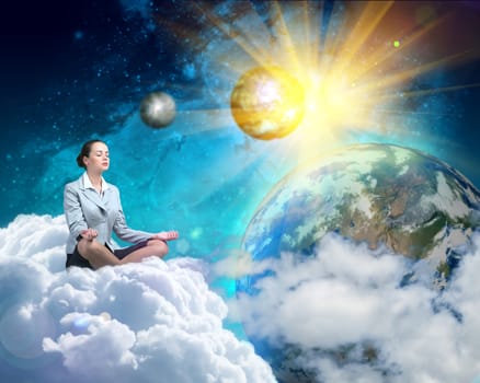 image of a businesswoman meditating in the clouds in space