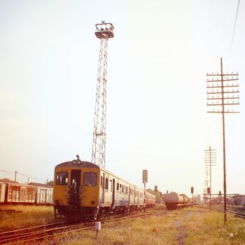 Old train at railway station with retro filter effect