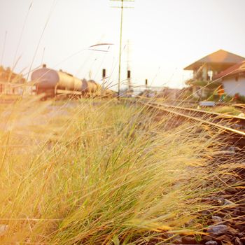Grass on old railway station with retro filter effect