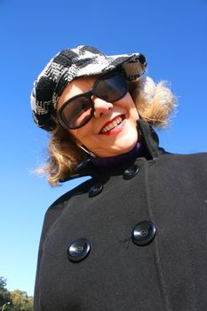 Portrait of a mature woman enjoying the sunlight on a beach.