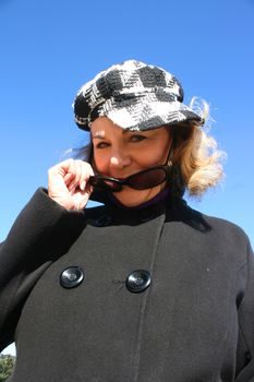 Portrait of a mature woman enjoying the sunlight on a beach.