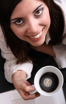 Portrait of a Hispanic young woman holding a cup of coffee.