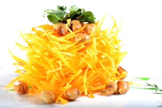 Chinese Food: Salad made of pumpkin slices and peanut kernels on a white background