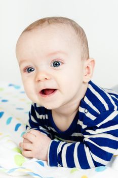 Funny cute blue-eyed baby. Little happy boy