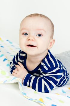 Funny cute blue-eyed baby. Little happy boy