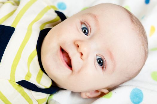 Funny cute blue-eyed baby. Little happy boy