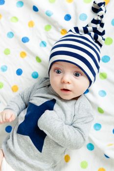 Funny cute blue-eyed baby. Little boy astonished