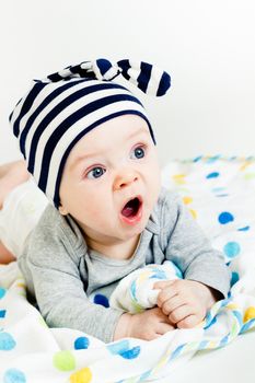 Funny cute blue-eyed baby. Little boy yawning
