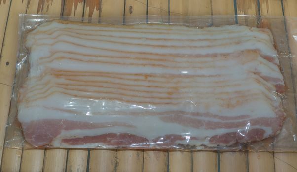 Fresh bacon strips in a plastic packaging