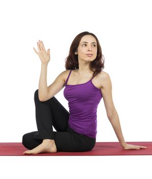 Young woman is doing Ardha Matsyendrasana pose in yoga.
