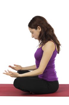 Young woman is doing meditation during yoga.