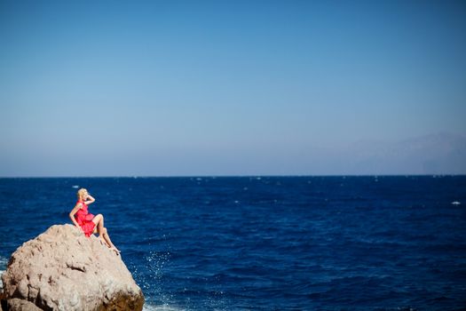 girl on the rock in the sea