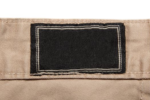 black label on brown cotton trousers