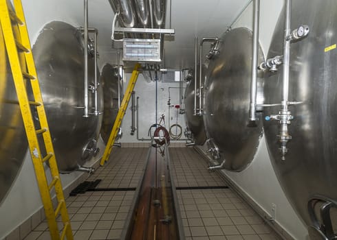 Horizontally laid lagering tanks at Van Honsebrouck Brewery in Belgium, circa March 2014.