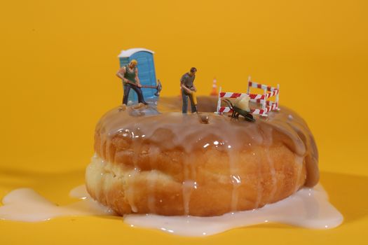 Miniature Police Officers in Conceptual Food Imagery With Doughnuts