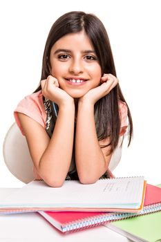 Cute little girl studying and smiling on desk