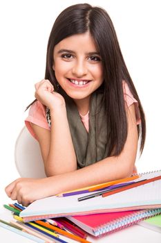 Cute little girl drawing with colorful pencils