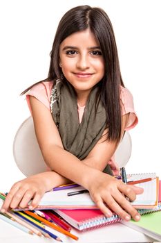 Cute little girl drawing with colorful pencils