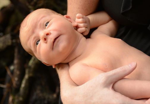 funny face on newborn infant who is looking away