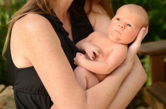 baby infant looking up at mother