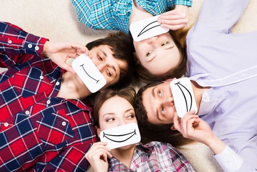 four young men lie together, applied to the face card with smiles