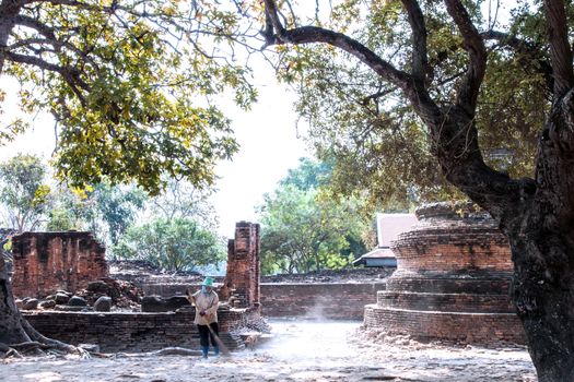 worker sweeper cleaning ancient temple with broom tool