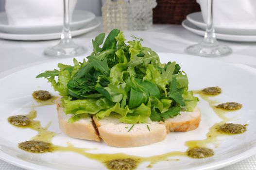 Slices of roasted chicken with lettuce mixes