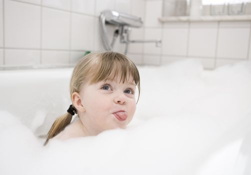 Little Girl in bath tube with bubbles