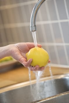 Close up of washing a lemon