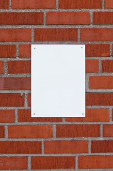 Brick wall with a blank sign